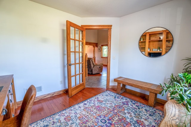 interior space with french doors and light hardwood / wood-style flooring