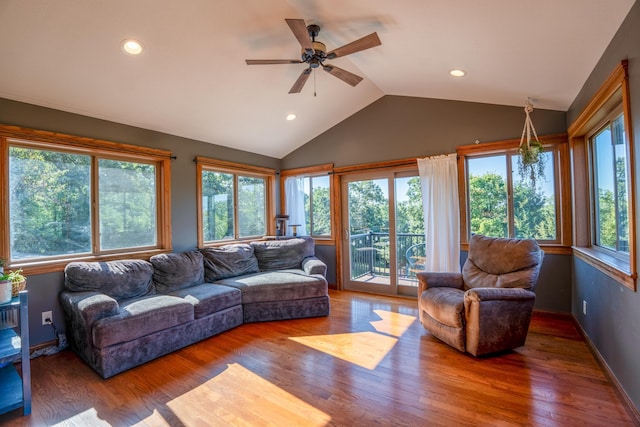 living room with ceiling fan, lofted ceiling, dark hardwood / wood-style floors, and a healthy amount of sunlight