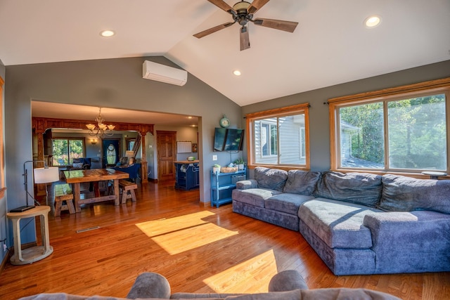 living room featuring ceiling fan with notable chandelier, lofted ceiling, hardwood / wood-style floors, and a wall mounted AC