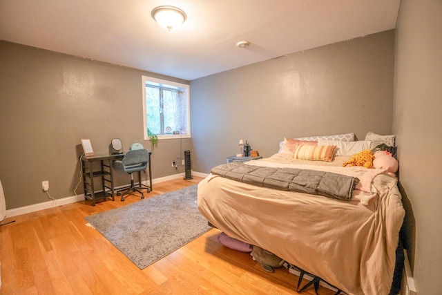 bedroom with hardwood / wood-style flooring