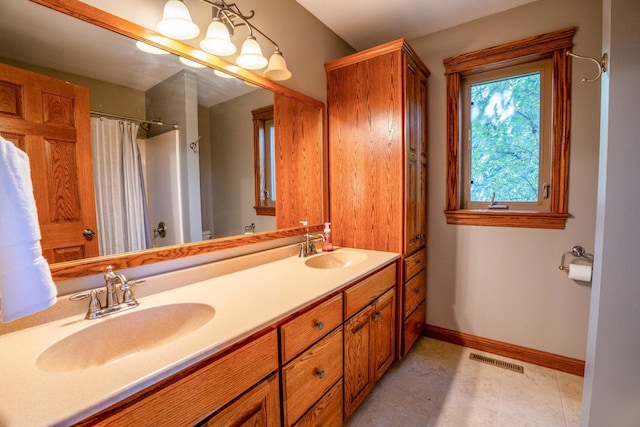 bathroom featuring vanity, curtained shower, and tile patterned floors