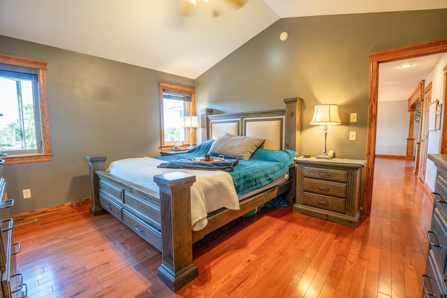 bedroom with vaulted ceiling and hardwood / wood-style flooring