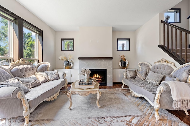 living room with hardwood / wood-style floors and a premium fireplace