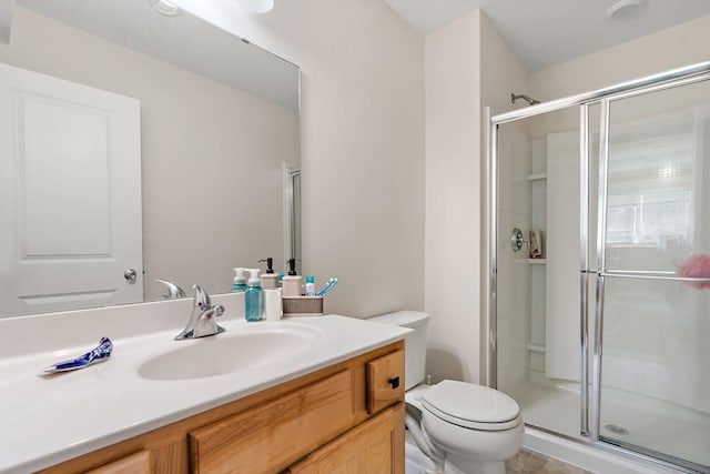 bathroom featuring vanity, toilet, and walk in shower