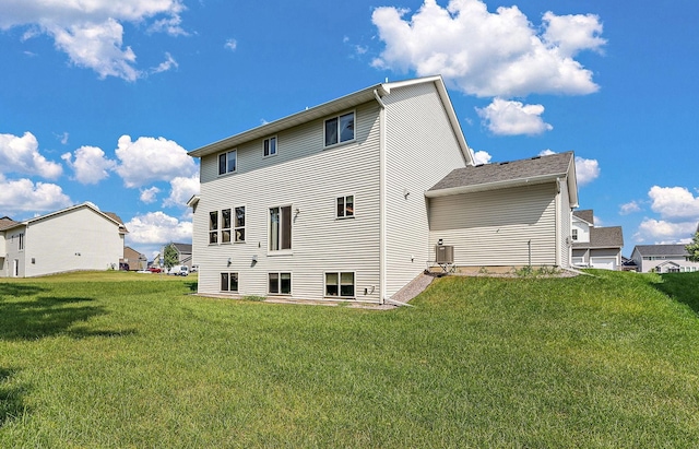 back of property featuring a lawn