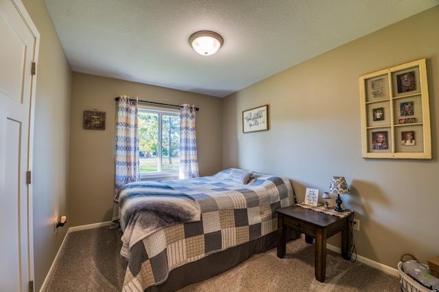 bedroom with carpet and a textured ceiling