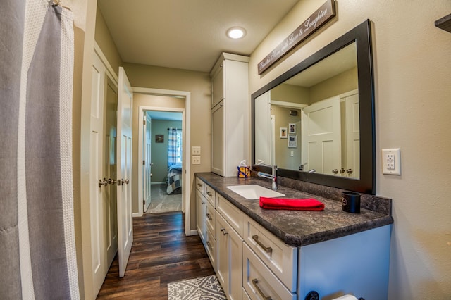 bathroom with hardwood / wood-style floors and vanity