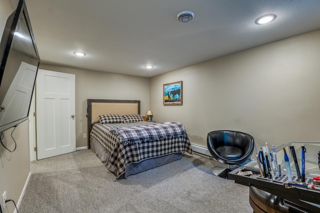 bedroom with light carpet and a baseboard radiator