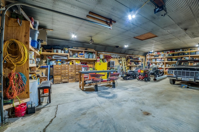 garage featuring a garage door opener and a workshop area