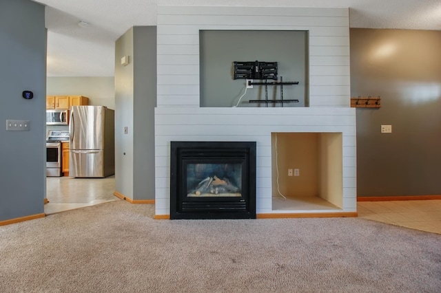 unfurnished living room with a fireplace, a textured ceiling, and light carpet