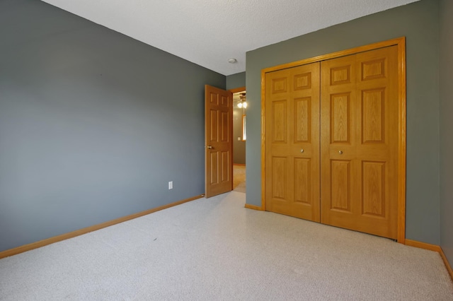 unfurnished bedroom with a textured ceiling and a closet