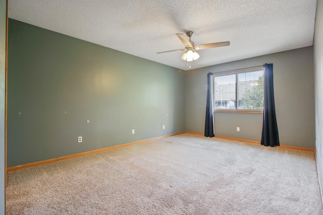 carpeted spare room with ceiling fan and a textured ceiling