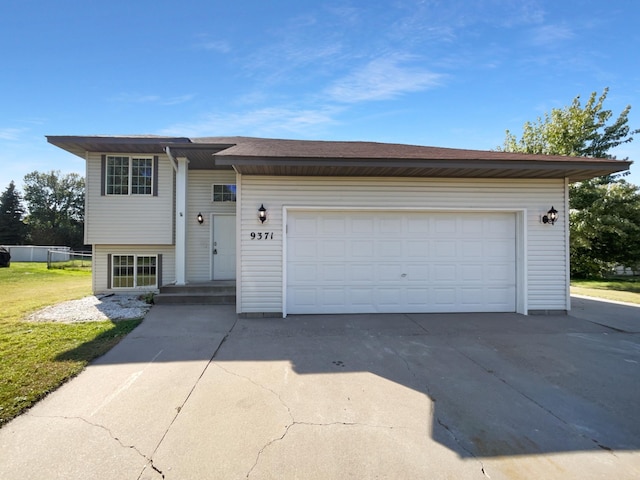 view of front of home with a garage and a front yard