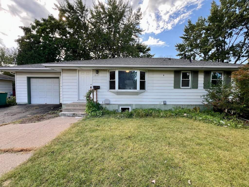 single story home with a front lawn and a garage