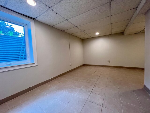 interior space featuring a drop ceiling and light tile patterned flooring