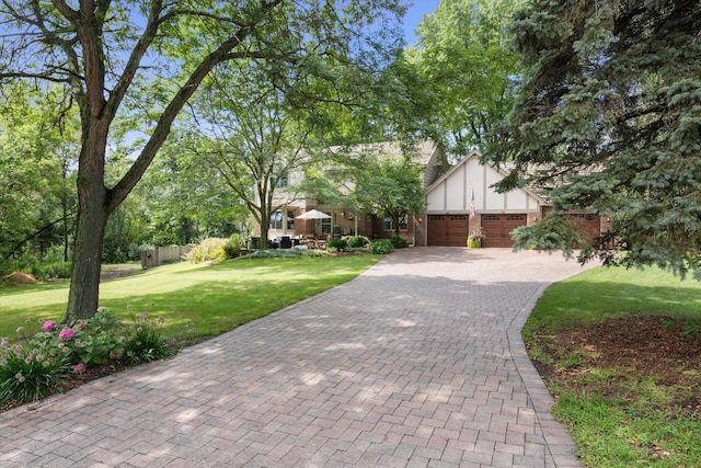 view of front of house with a front yard and a garage