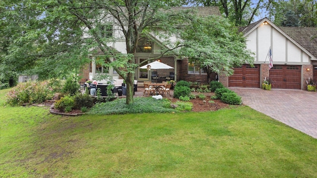 view of front of property with a front lawn and a garage