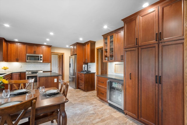 kitchen featuring wine cooler, stainless steel appliances, and tasteful backsplash