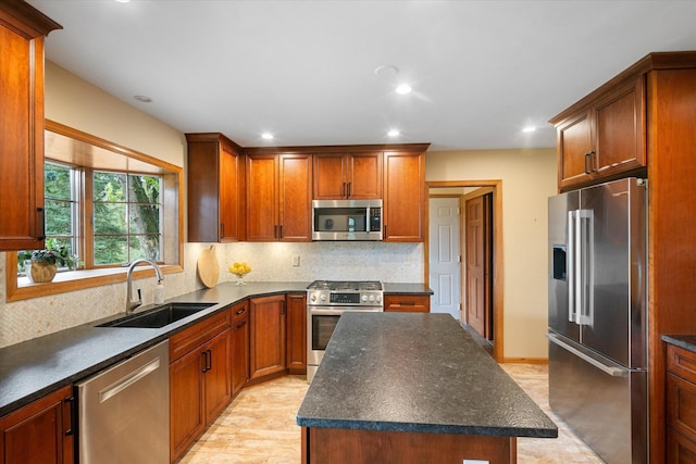 kitchen with decorative backsplash, a kitchen island, stainless steel appliances, light hardwood / wood-style flooring, and sink