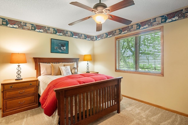 bedroom featuring light carpet, ceiling fan, and a textured ceiling