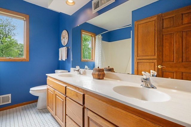 bathroom featuring tile patterned floors, a shower with curtain, vanity, and toilet