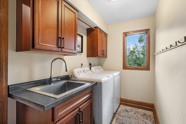 washroom featuring cabinets, washing machine and clothes dryer, and sink