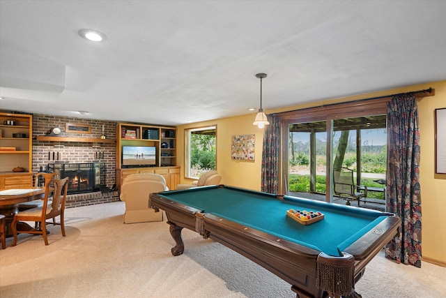 game room with a brick fireplace, billiards, and light carpet