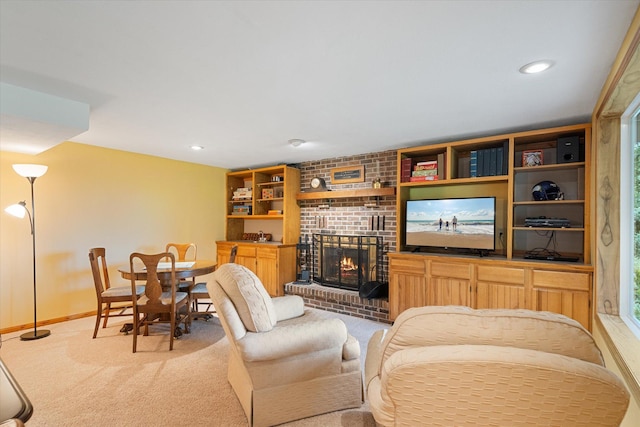 carpeted living room with a brick fireplace