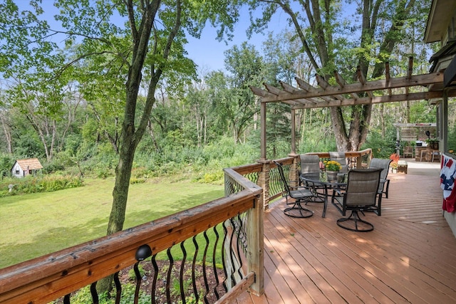 deck with an outbuilding, a yard, and a pergola