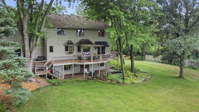 back of house featuring a wooden deck and a yard