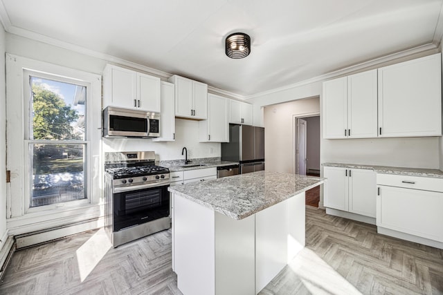 kitchen featuring white cabinets, sink, light parquet flooring, stainless steel appliances, and a center island