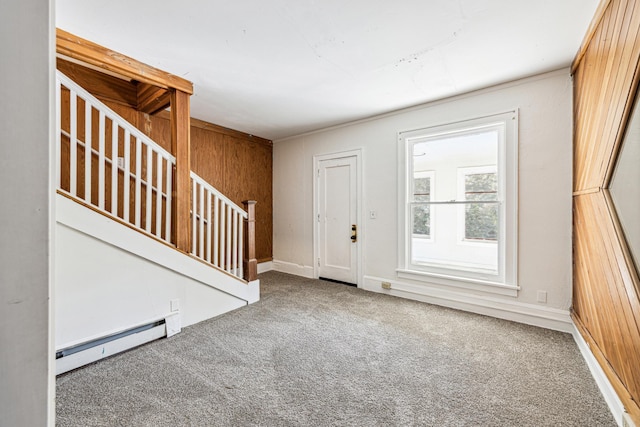 entryway featuring carpet, wooden walls, and baseboard heating