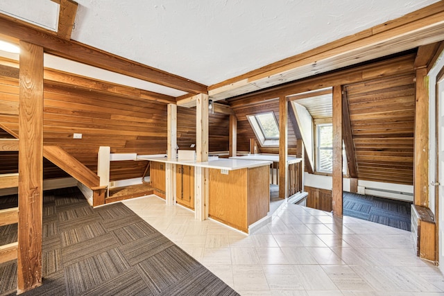 interior space with a skylight and wood walls