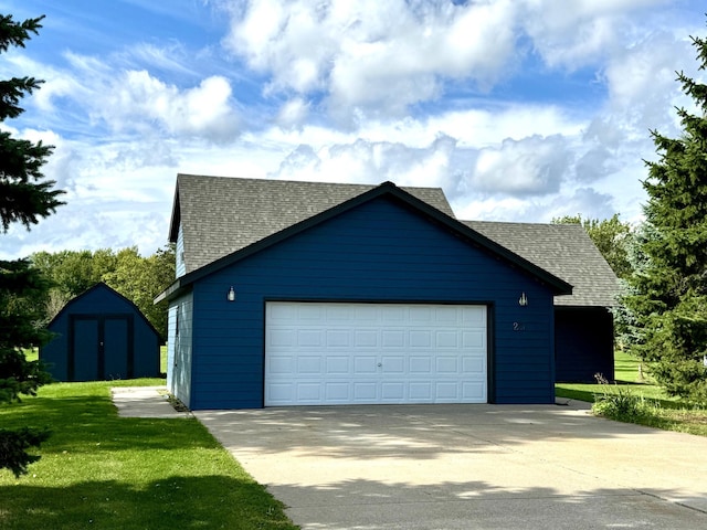 view of home's exterior featuring a garage, a yard, and an outbuilding