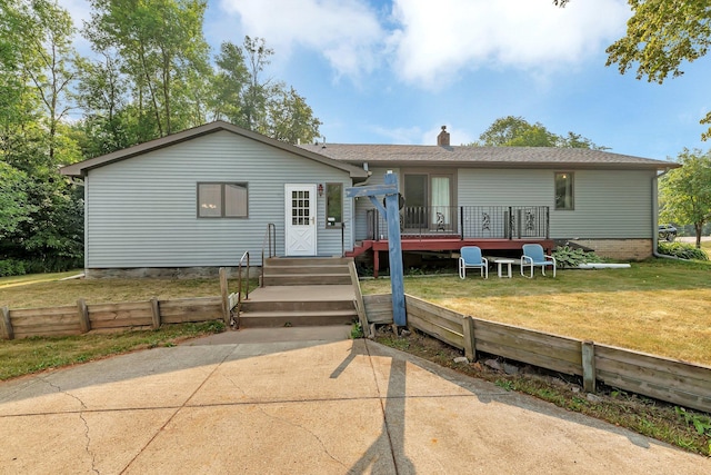 view of front facade with a front lawn and a deck