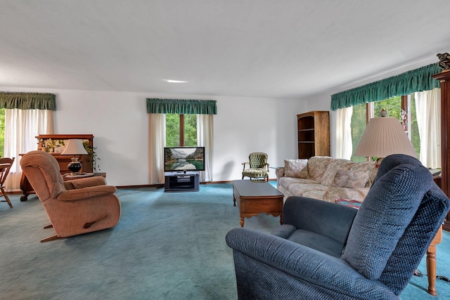 living room featuring a wealth of natural light, baseboards, and carpet