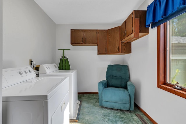 washroom featuring washing machine and clothes dryer, light carpet, cabinet space, and a healthy amount of sunlight