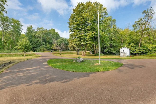surrounding community featuring a yard, a shed, and an outdoor structure