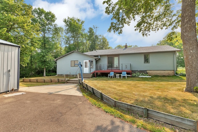 back of house featuring a yard, a chimney, and a wooden deck