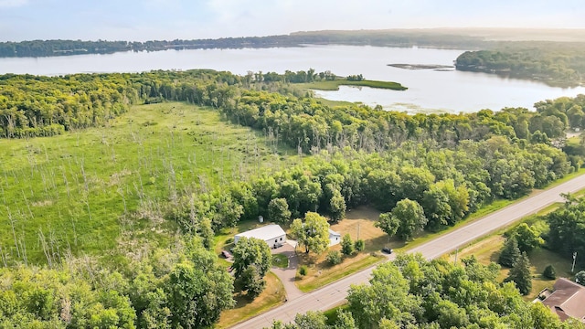 drone / aerial view with a forest view and a water view