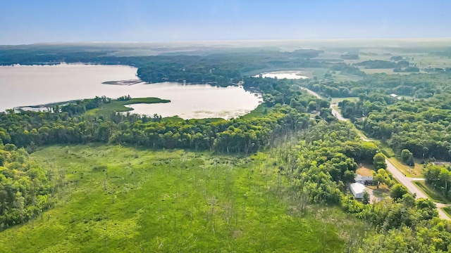 birds eye view of property featuring a wooded view and a water view
