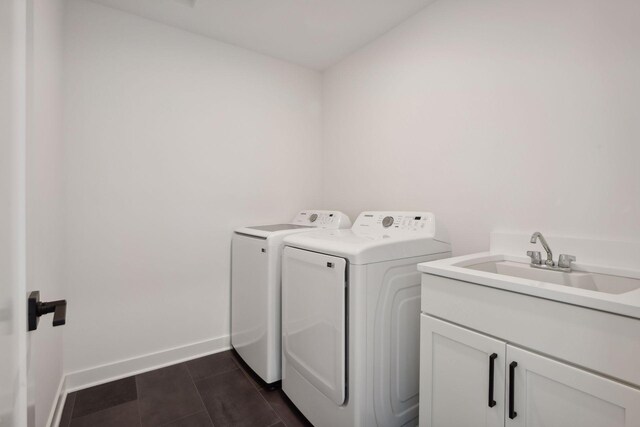 clothes washing area featuring cabinets, independent washer and dryer, and sink