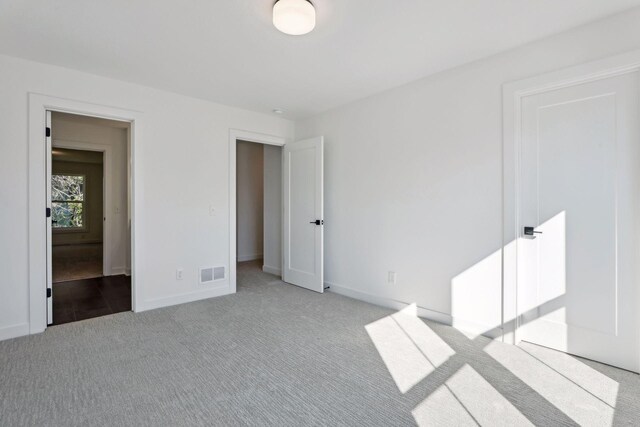 unfurnished bedroom with light colored carpet