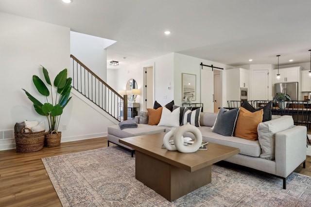 living room with hardwood / wood-style floors and a barn door