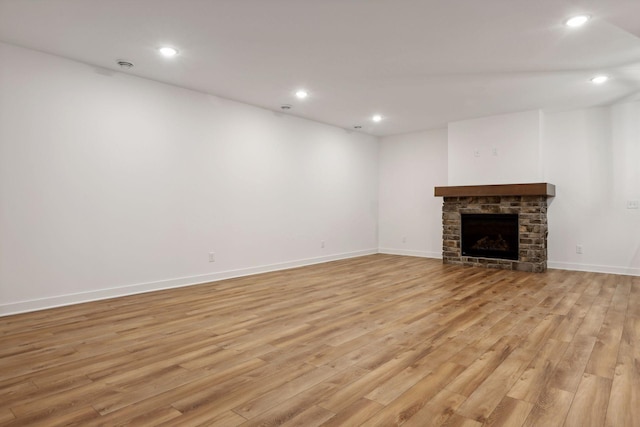 unfurnished living room with a fireplace and light hardwood / wood-style floors