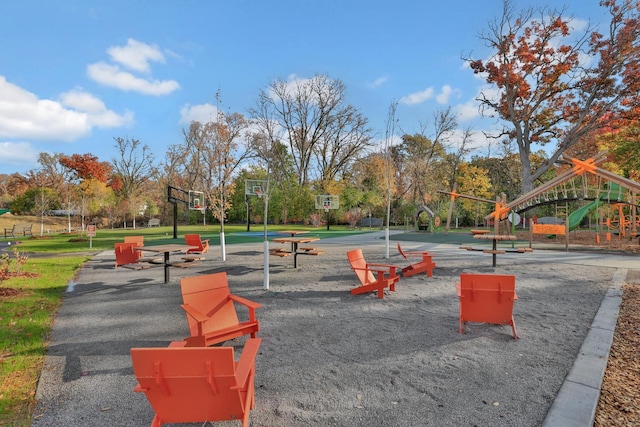 view of property's community featuring a playground and basketball hoop