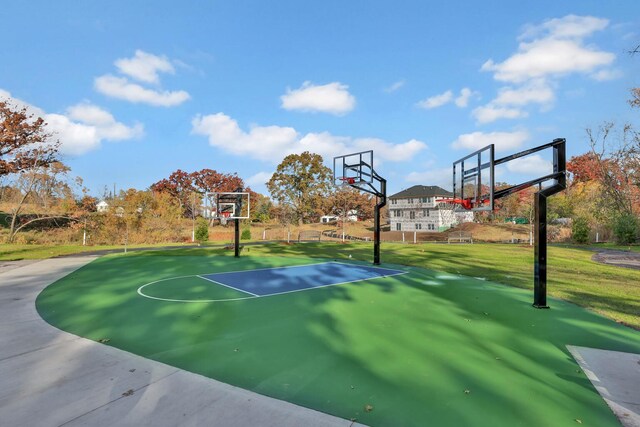 view of basketball court featuring community basketball court, a yard, and fence