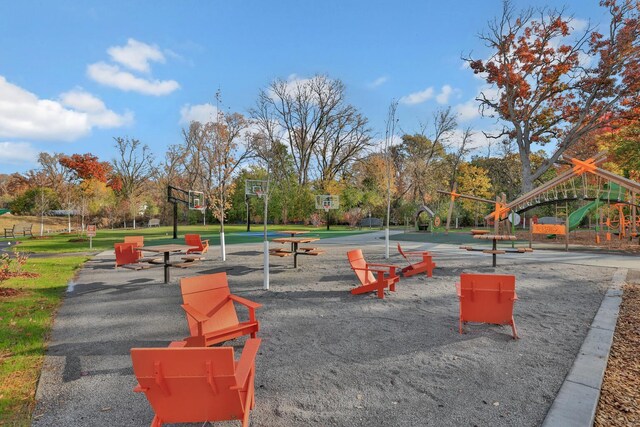 view of property's community featuring playground community, a lawn, and community basketball court