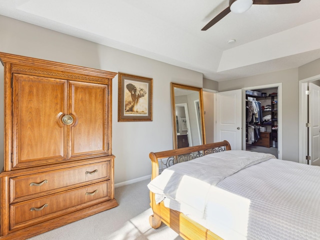 carpeted bedroom featuring a spacious closet, ceiling fan, and a closet