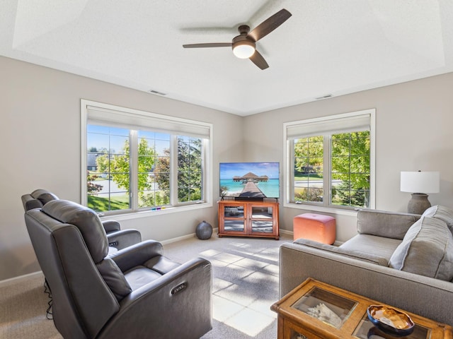 carpeted living room with plenty of natural light and ceiling fan